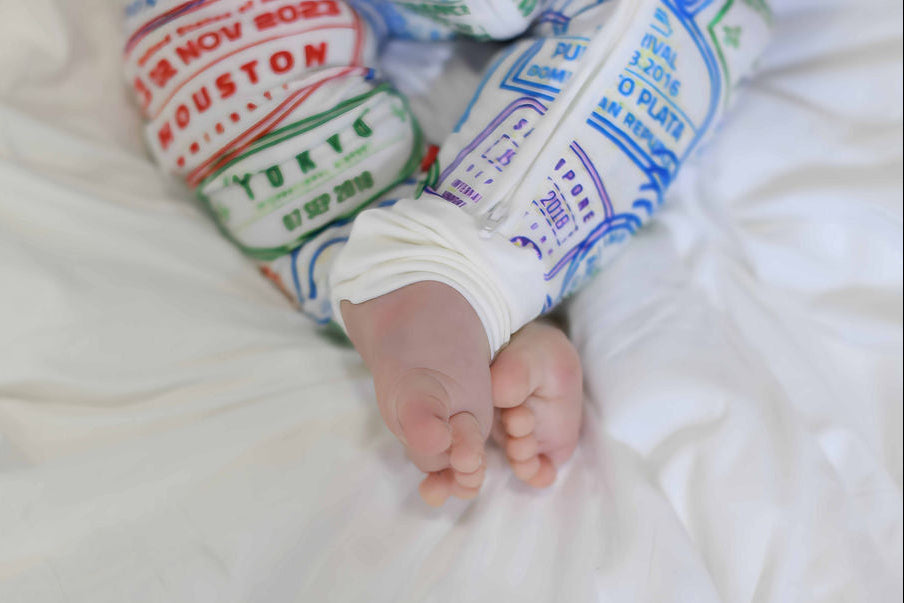 Passport stamp sleeper with foldable footed sleeper baby feet