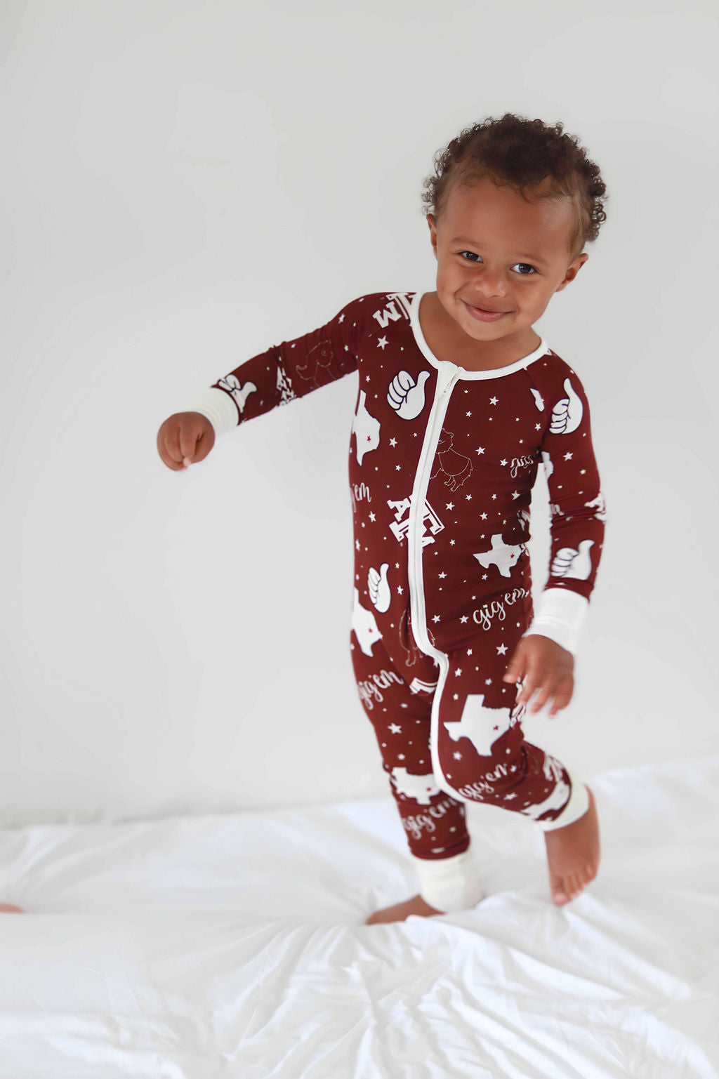 Toddler running in bamboo zippie in Texas A&M Print