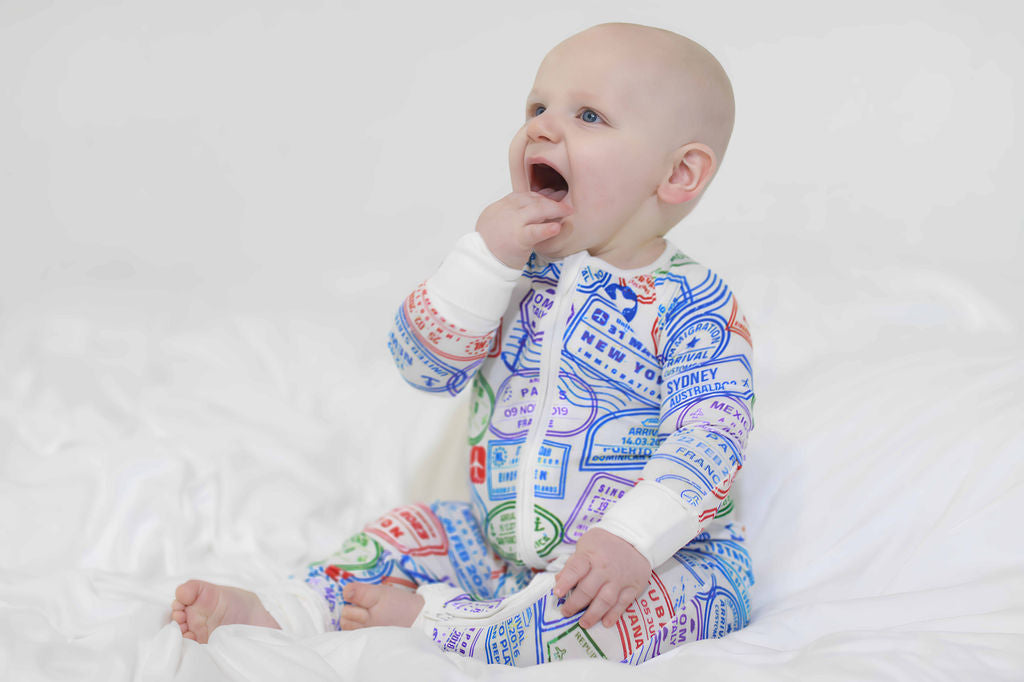 Convertible hands and feet travel baby with passport stamps