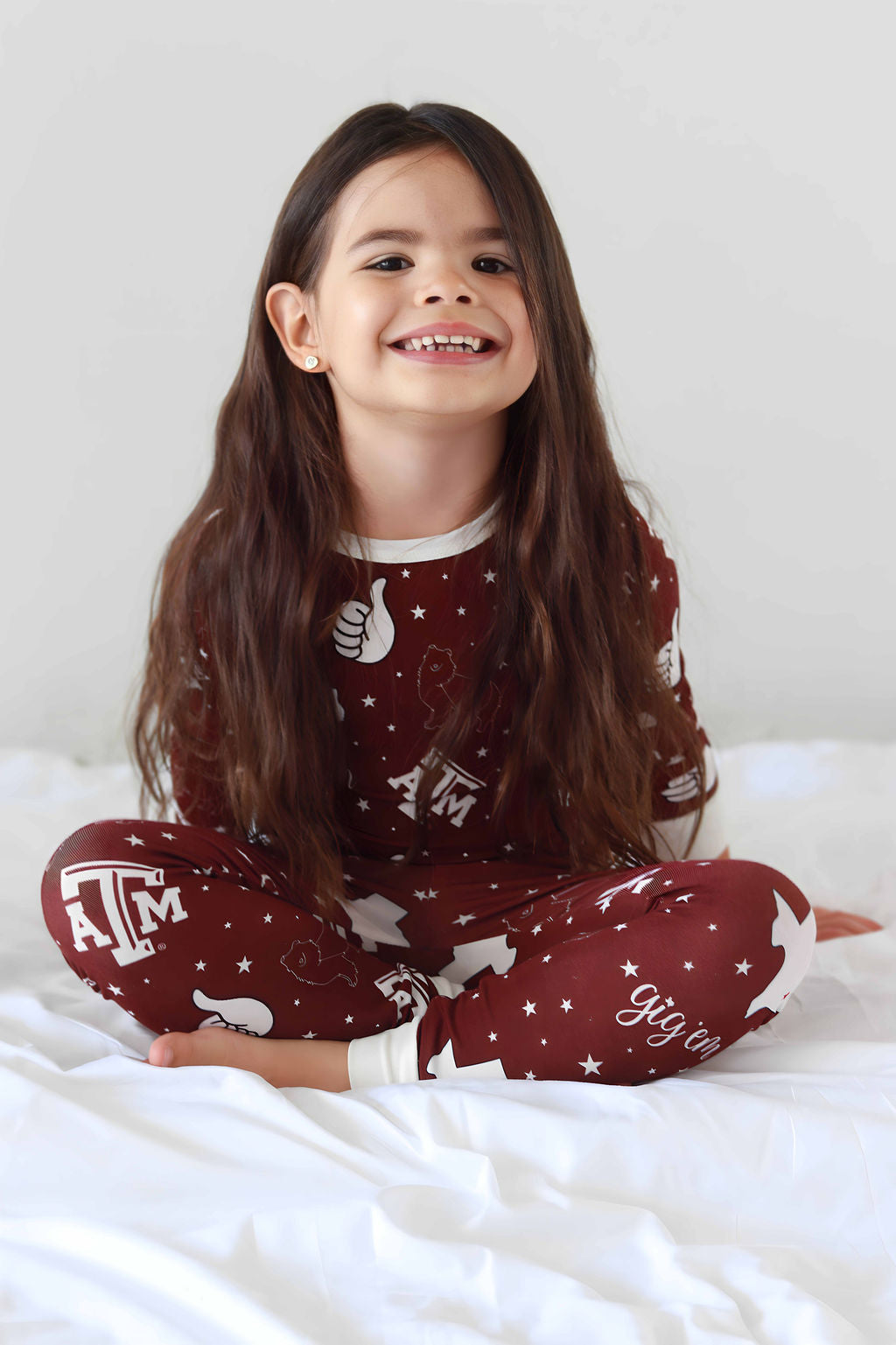 Toddler sitting in Texas A&M Two Piece Long sleeve bamboo Pajama