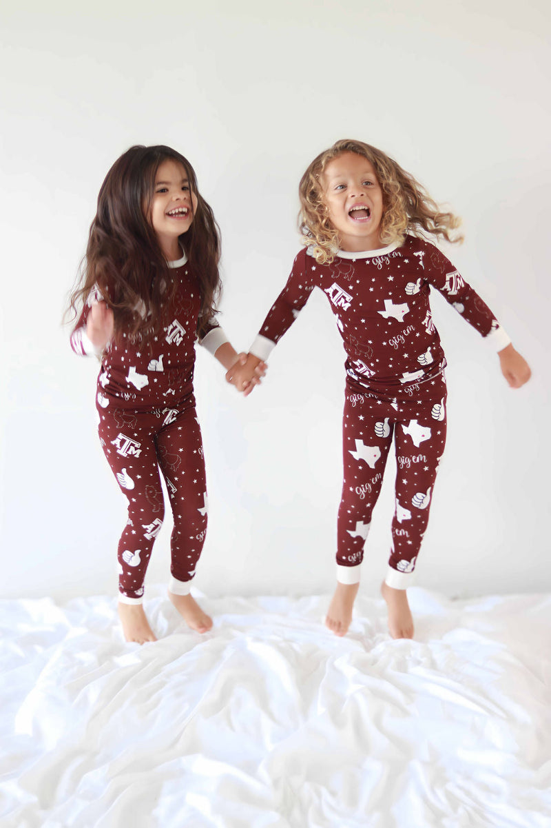 Texas A&M Print toddlers jumping in two piece pajamas
