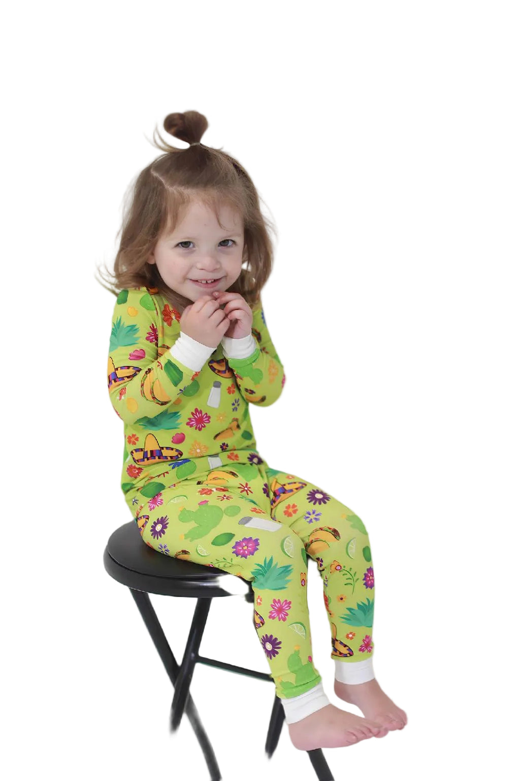 Toddler Sitting in Bright LIme Green Two piece bamboo pajamas
